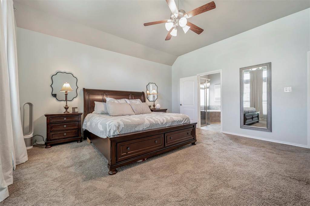 Spacious Primary bedroom with tall ceilings with floor to ceiling windows
