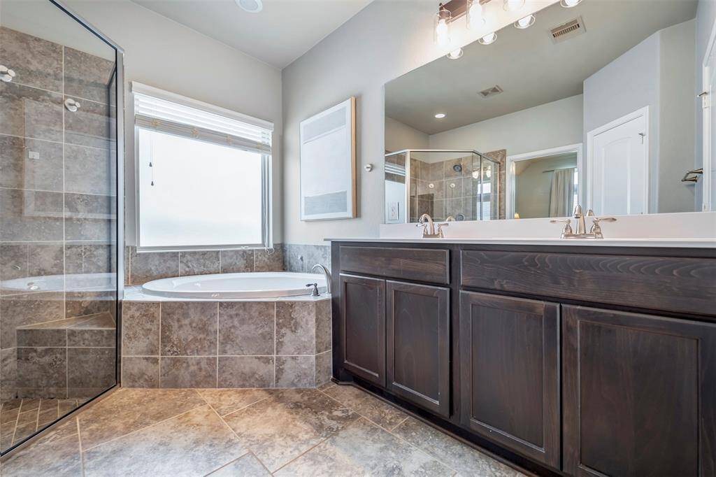 Primary retreat includes double sinks, standing shower, and soaker tub