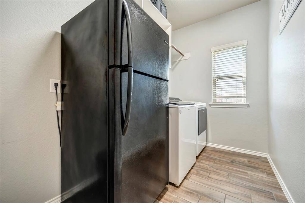 Spacious laundry room with fridge space
