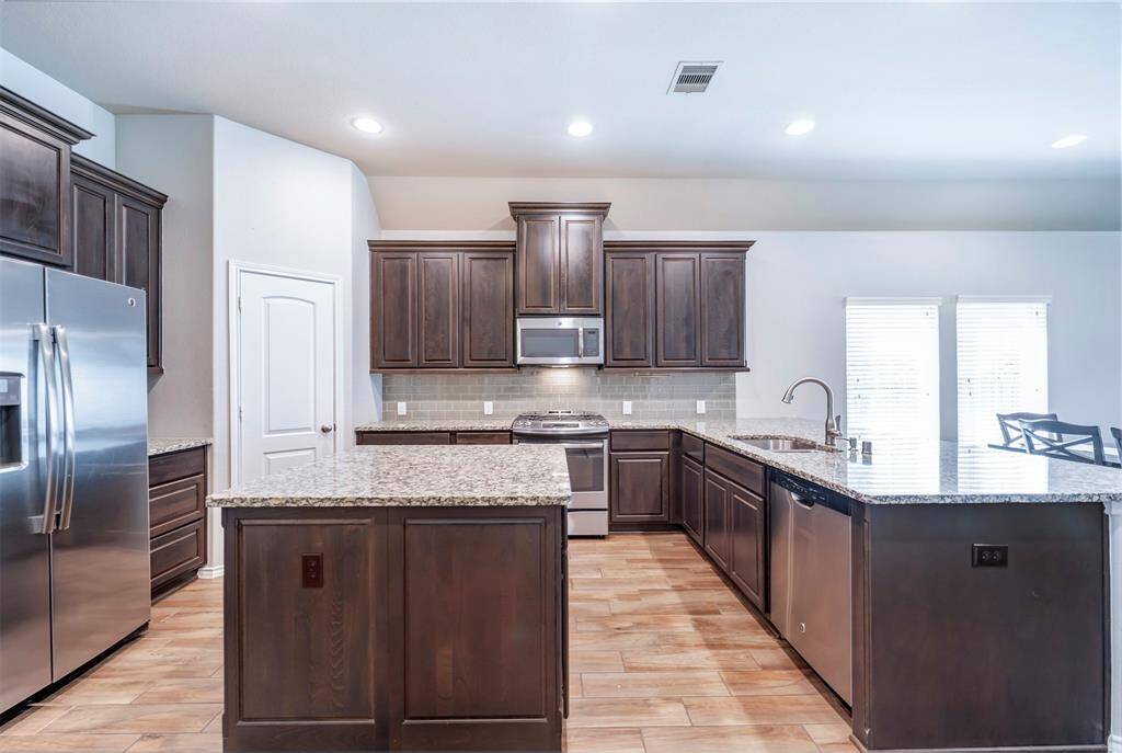 Kitchen has plenty of cabinets & countertop space including island
