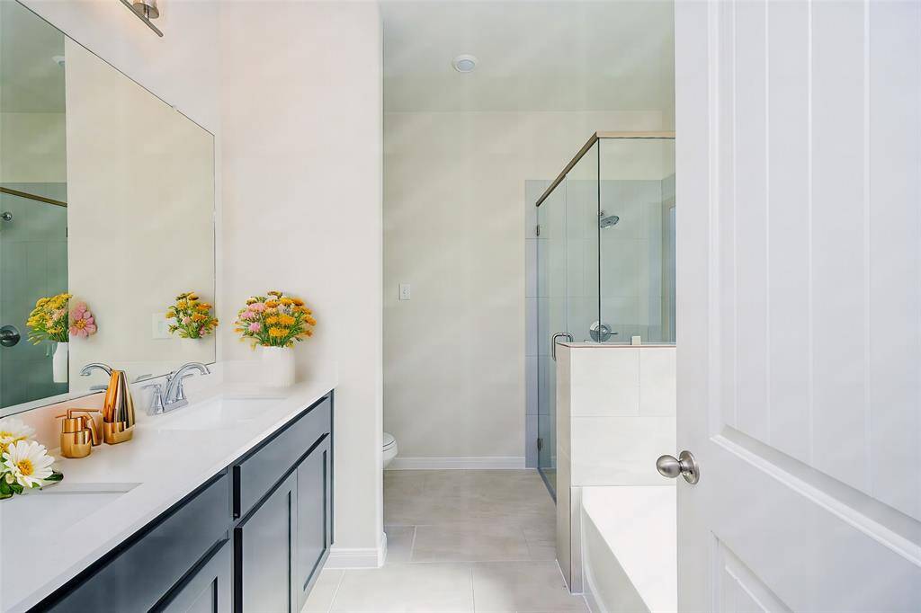 Streamlined placement of walk-in shower and tub share generous paths in this ensuite bath.