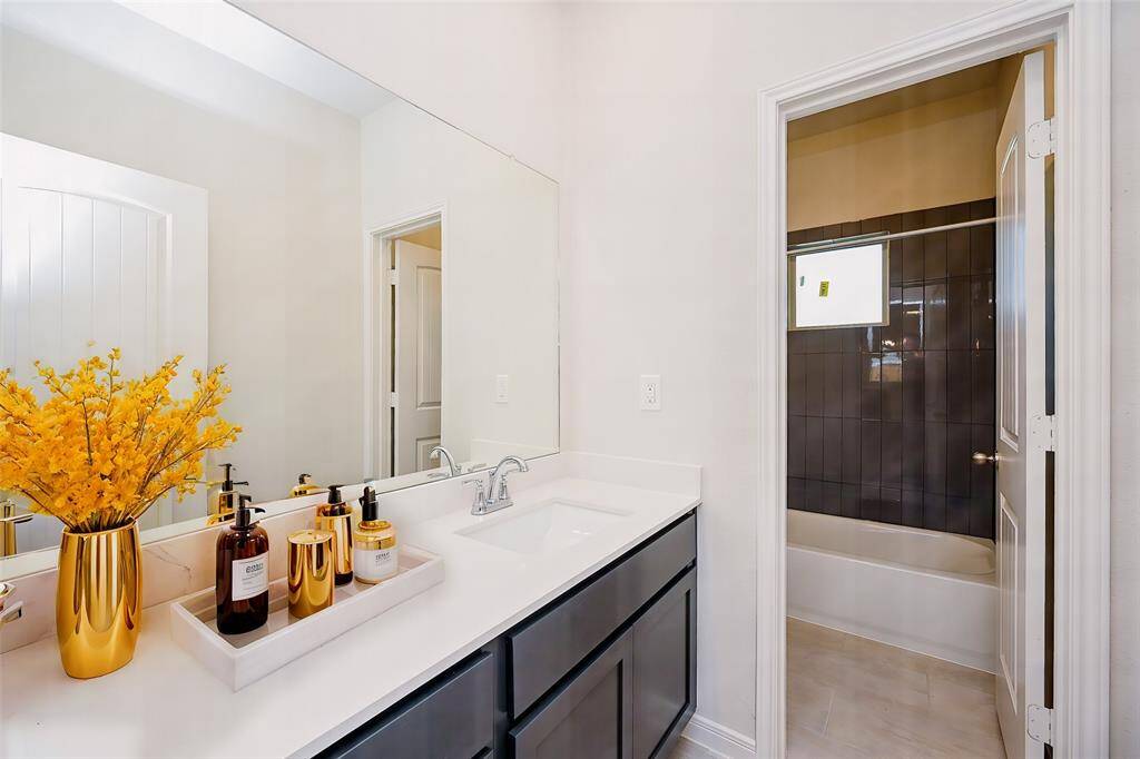 Privacy is ensured in this second bath, with combined shower/bathtub.
