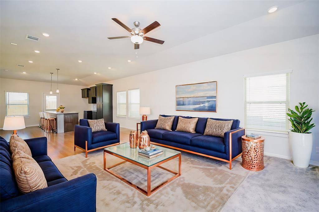 The timeless beauty and versatility of the open floor plan design concept is clearly appreciated here, in this huge blended living/kitchen/dining area in your bright, airy home.