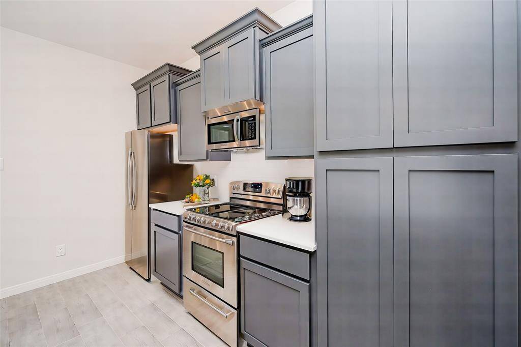 Rustic sophistication is seen here in pewter toned cabinetry in this truly workable kitchen.