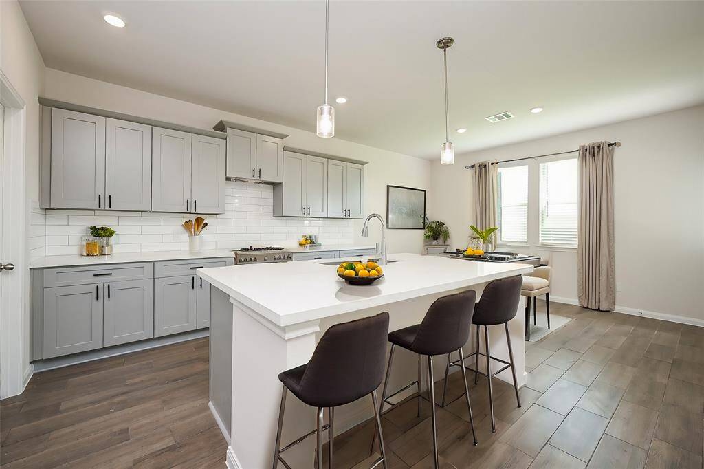 Counter seating --- on either side of the island --- is comfortable in this kitchen setting.