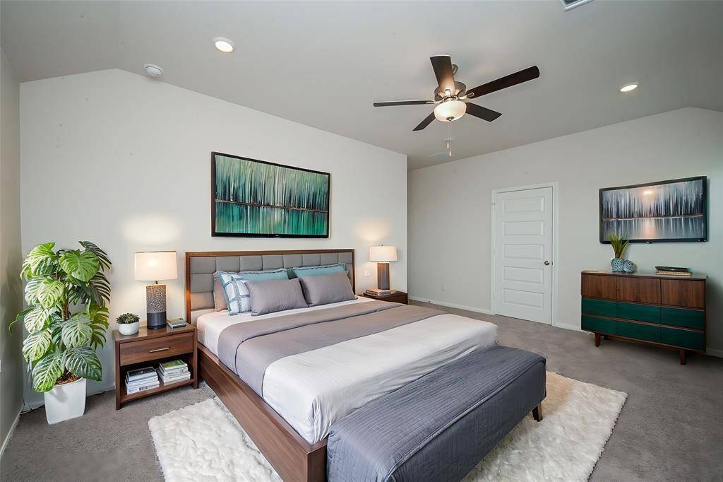 This gorgeous contemporary carpeted primary suite will become your private place of complete peace and repose; with ensuite bath peeking out, up left.