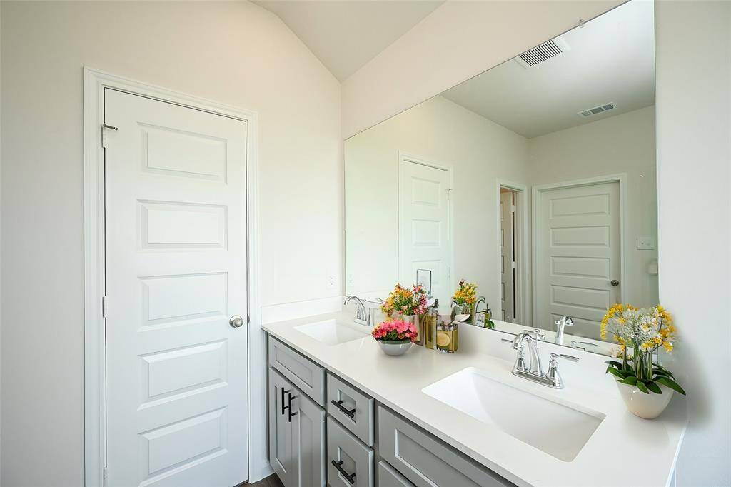 Dual sinks set in quartz? counter tops welcome pampered relaxation and refreshment.