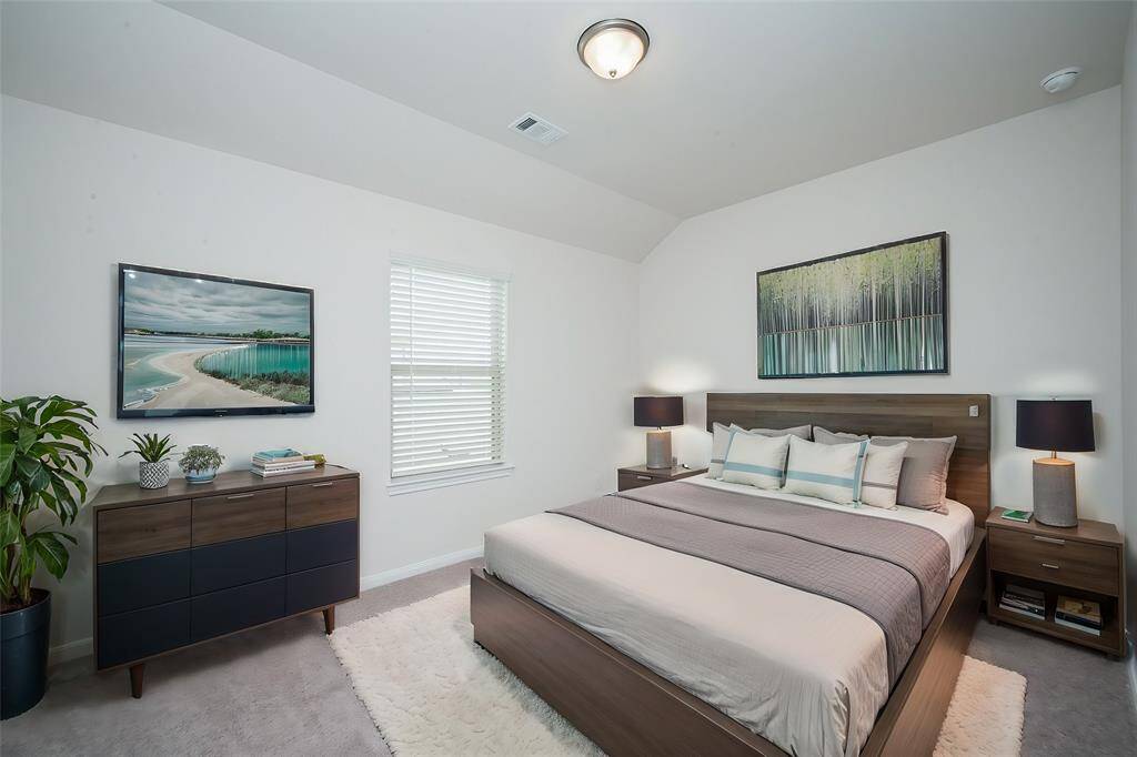 A sizeable guest bedroom offers all the comforts of a lovely suite.