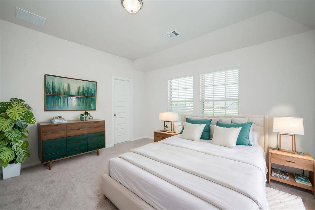 Another carpeted bedroom invites both family and guests.