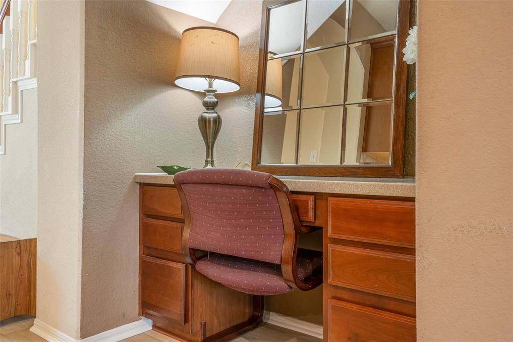 Cozy built-in desk nook. Ideal for a small office or study area, with additional storage in wooden drawers. Inviting atmosphere.