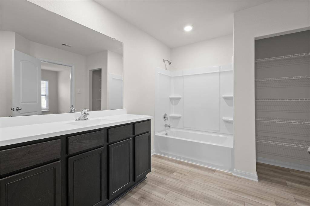Primary Ensuite with spacious countertop with bathtub/shower combo. Wonderful storage!