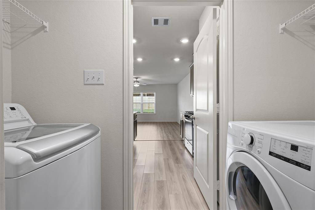 The laundry room is centrally located off the kitchen area.
