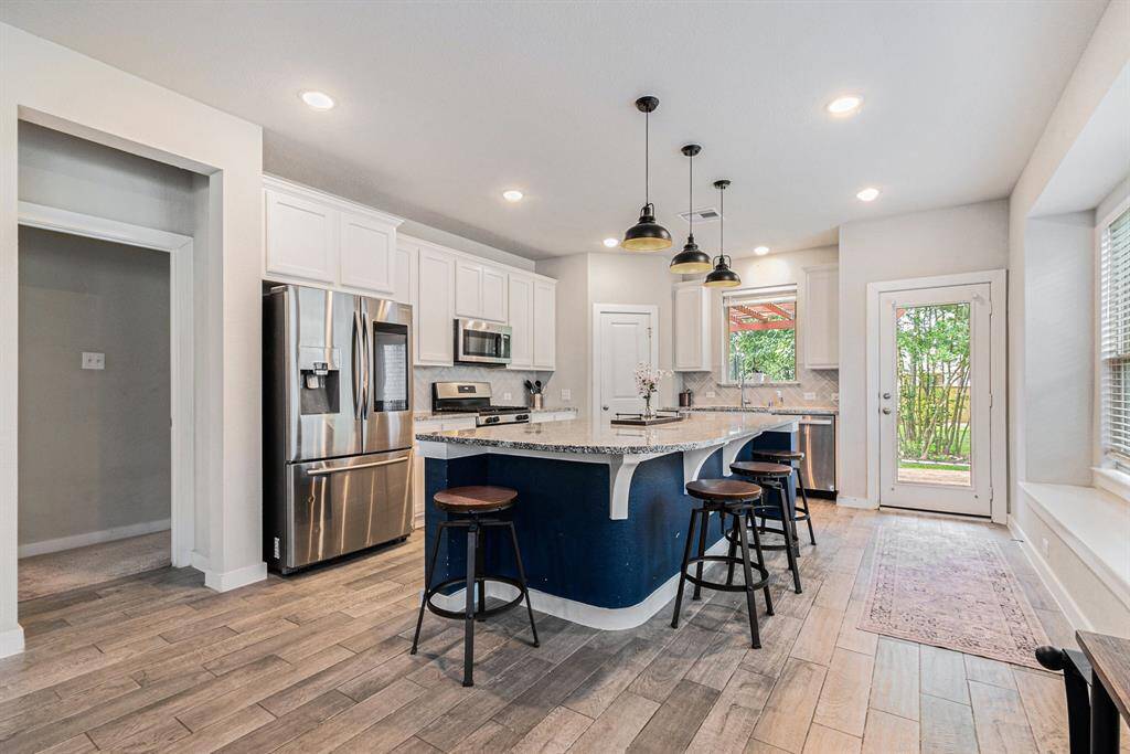 Beautiful kitchen with large island and eat in bar.
