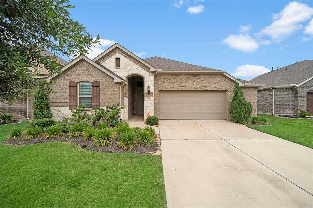 Charming one-story home with stone elevation in Lakes of Bella Terra.