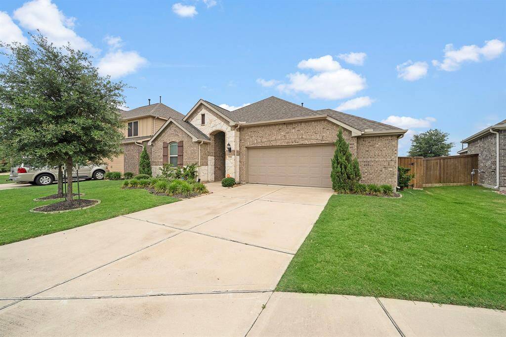 A charming single-story brick home with a two-car garage.