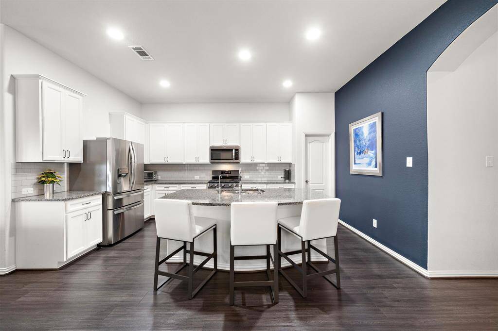 Expansive kitchen with elegant 42" white cabinets.