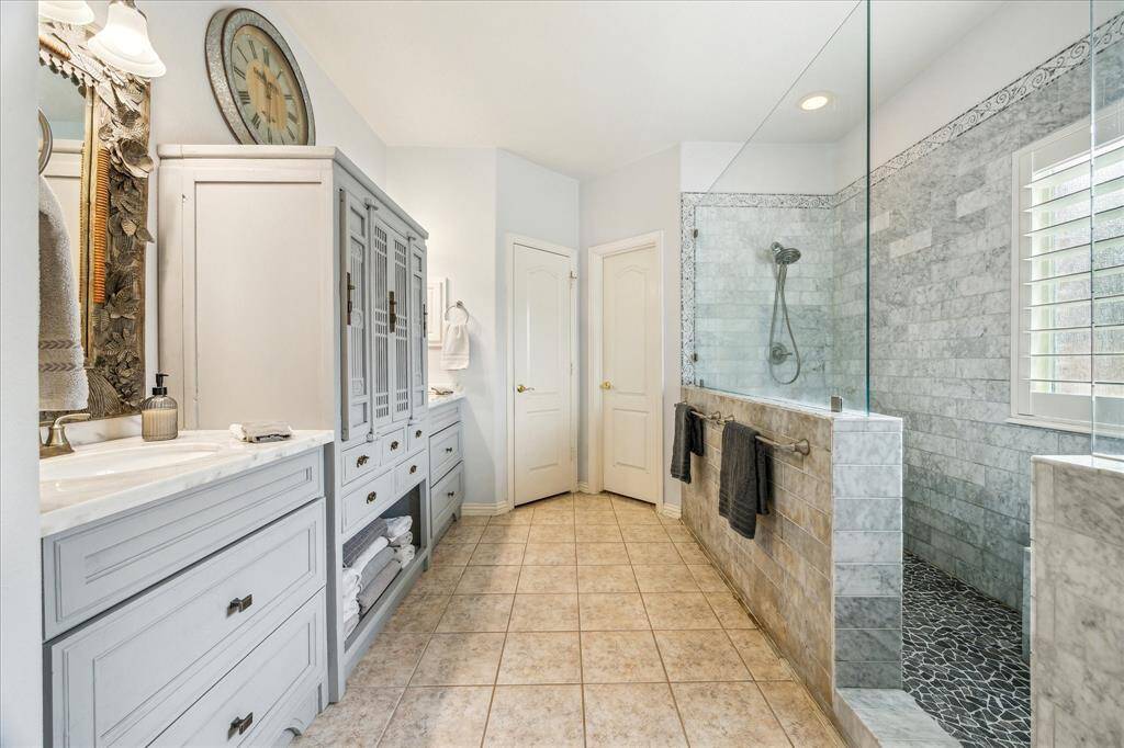 Master En-Suite is truly a Spa Retreat!!!!  Custom Designed Cabinetry with Dual Vanities ~ Stunning Designer Inspired Walk-in Shower!!!  Absolutely looks like something you'd expect to see on HGTV!!!!