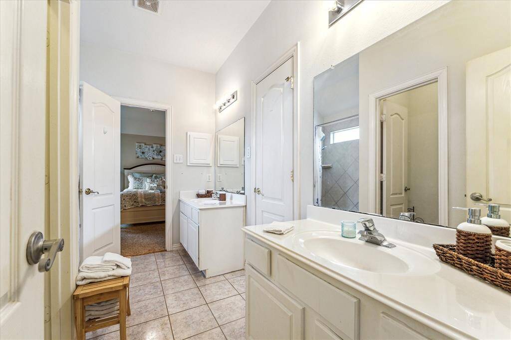Jack and Jill Bath is conveniently located between the First and Second Upstairs Bedrooms with Direct Access from each of these bedrooms.  This Spacious Bathroom Features Double Vanities, Dual Sinks and Lots of Storage!!!  Perfect for sharing!!!