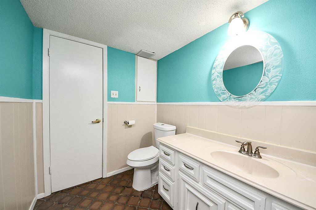 Half bathroom downstairsColorful and charming half bath on the main floor with updated fixtures, built-in storage, and unique tile flooring.