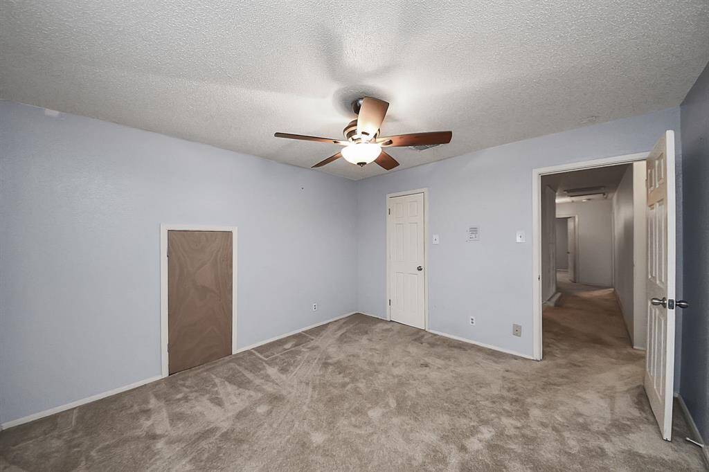 Bedroom 3 – Roomy third bedroom with ceiling fan, soft carpet, and direct access to hallway and closet space.