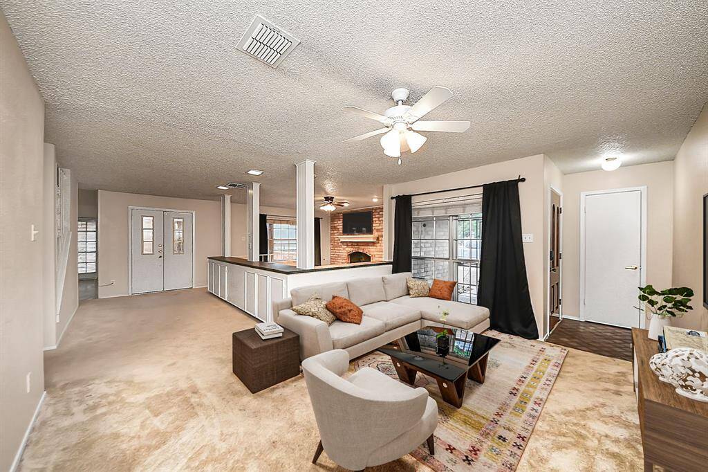 Living Room: Bright and spacious main living area. Virtual staging used to help visualize the space.