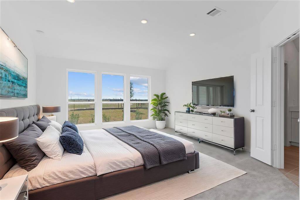 Primary suite tucked away from all the guest bedroom with an amazing lake view!  **Photo is Virtually Staged**