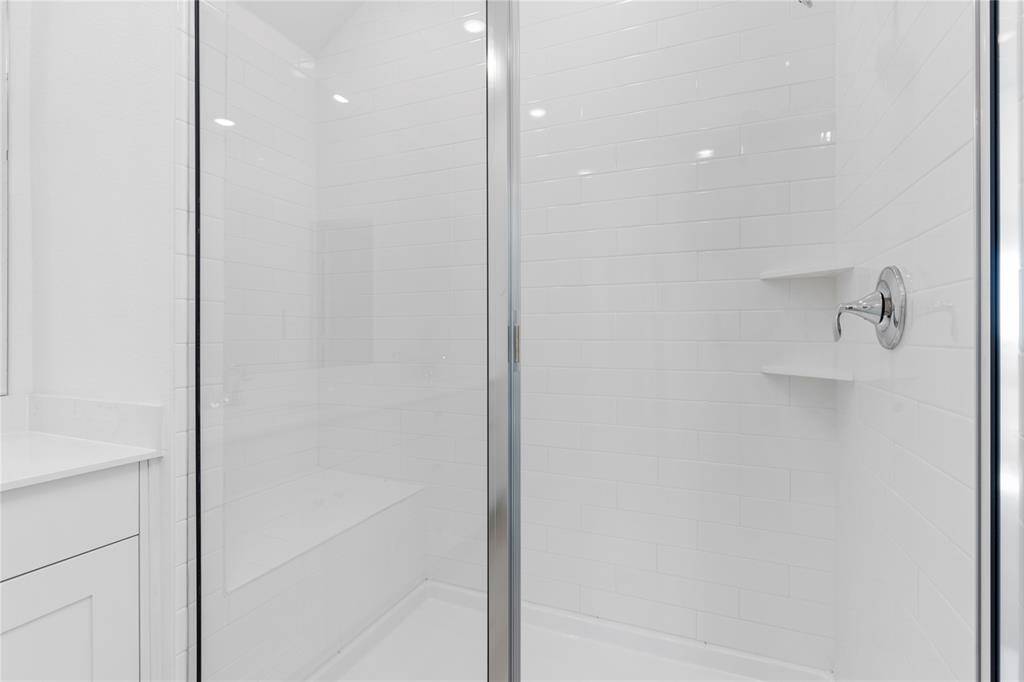 Massive shower made for two with sitting bench for those ladies to shave their legs.