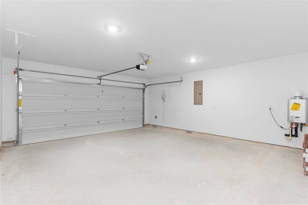 Single large garage door for easy access!  Tankless water heater that will never run out of hot water!