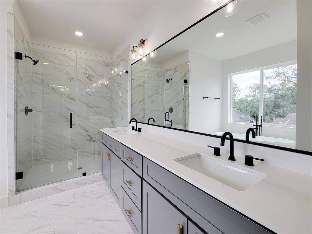 primary bathroom has 2 sinks and separate shower
