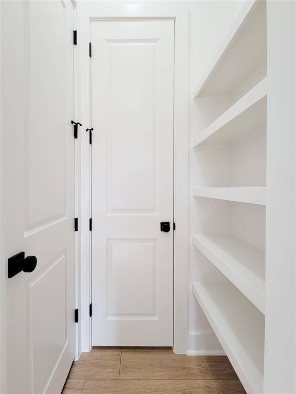 half bath with closet & shelving off entry way