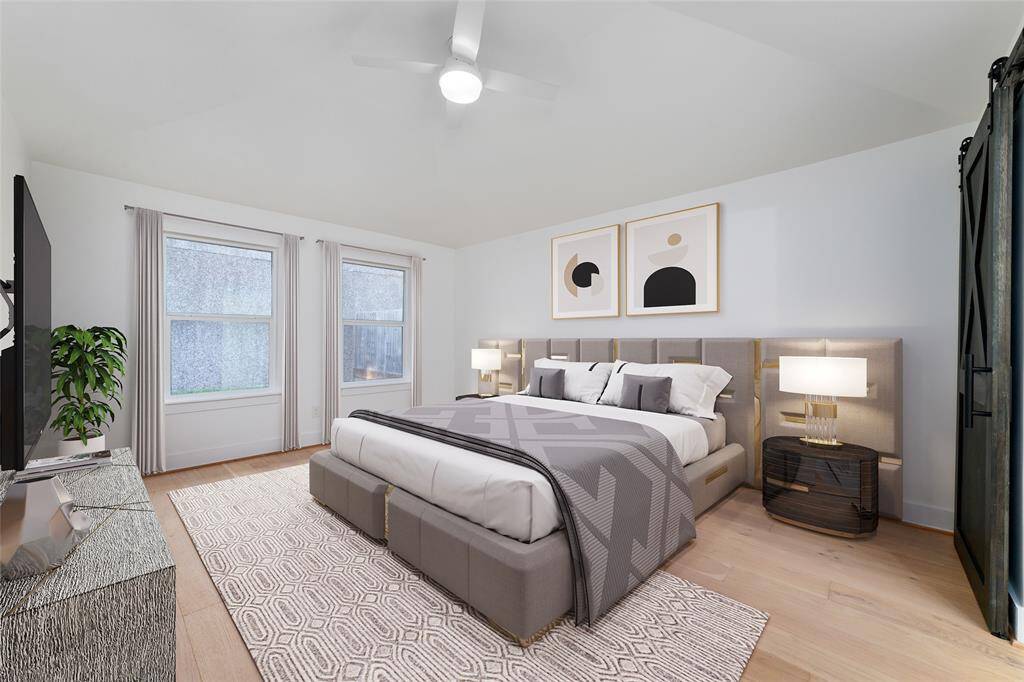 Primary bedroom **virtually staged** toward the back of the home, for added privacy. The barndoor leading into the primary bathroom. Ready to see!?
