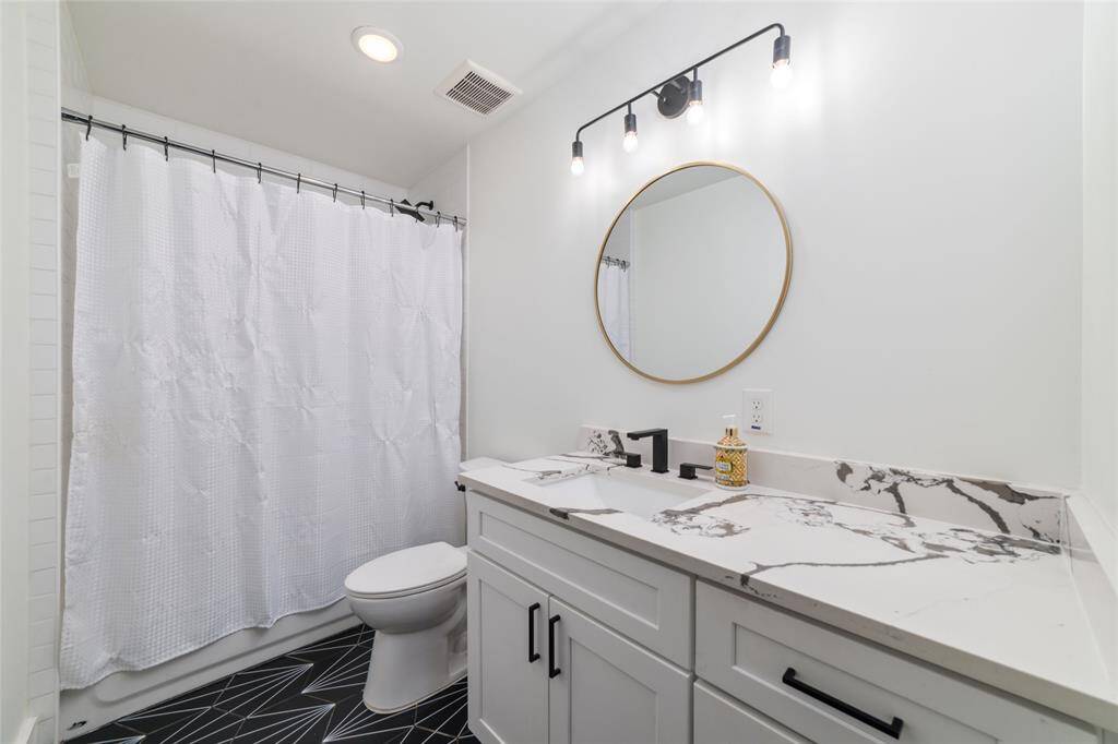 Shared bedroom for the first two rooms of the home. Behind that shower curtain is the full herringbone tile laid throughout the wall.