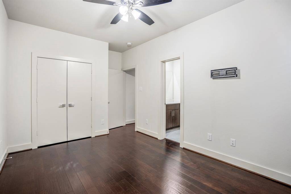 Second main-floor bedroom with ceiling fan and large closet.