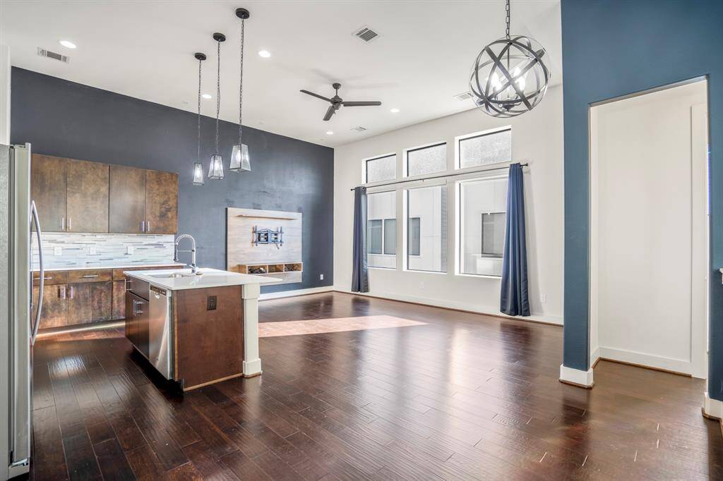 Open-concept living room with great natural light and high ceilings.