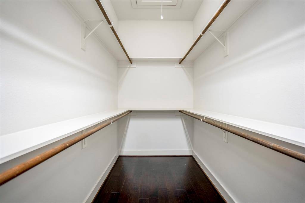 Generous walk-in closet with built-in shelving.