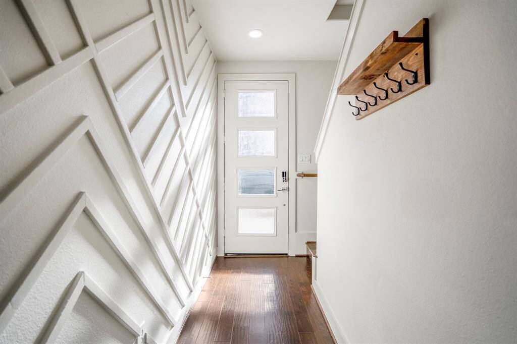 Contemporary hallway with wood flooring and clean lines.