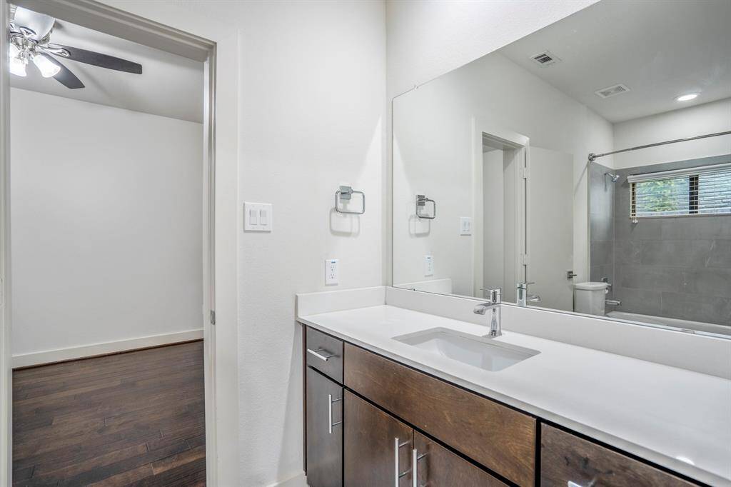 Stylish downstairs full bath with modern fixtures and ample counter space.