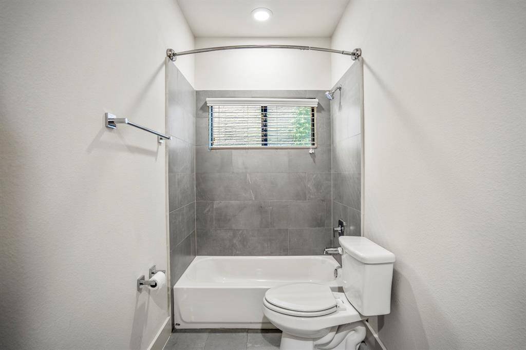 Stylish downstairs full bath with modern fixtures and ample counter space.