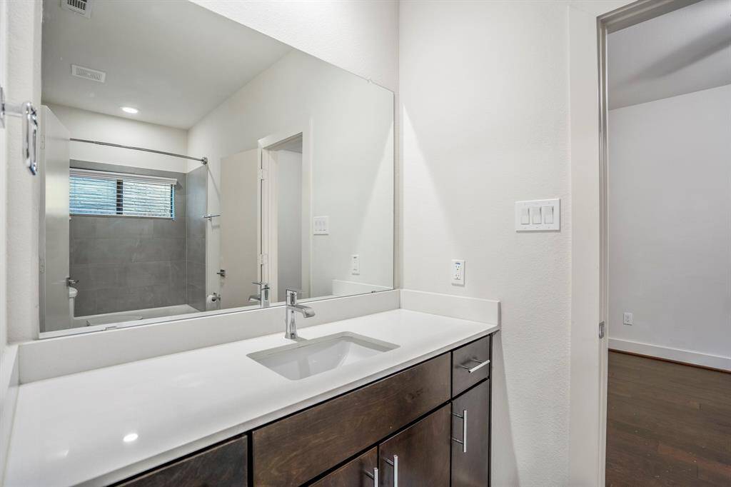 Stylish downstairs full bath with modern fixtures and ample counter space.