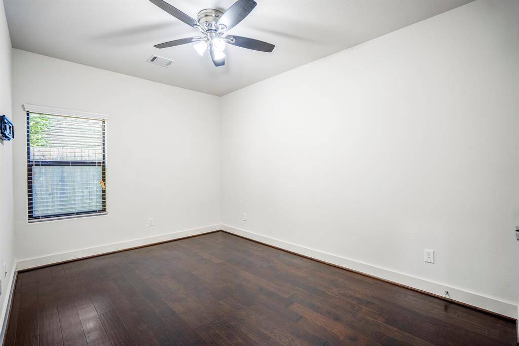 Second main-floor bedroom with ceiling fan and large closet.