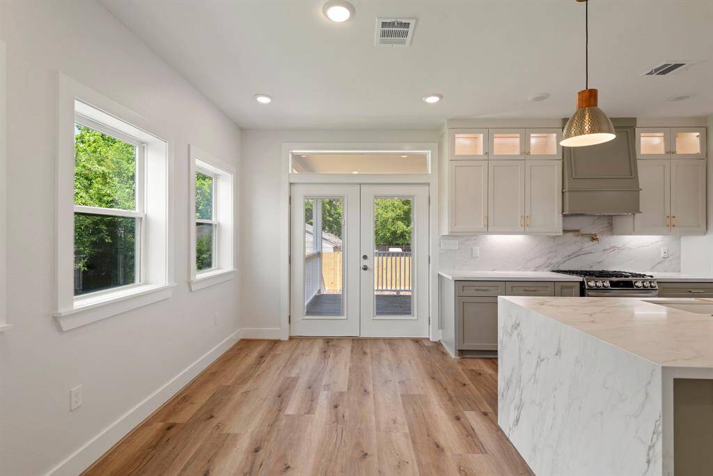 The bright breakfast area catches the morning sun just right, making every cup of coffee feel like a mini-vacation. Plus, those porch doors open wide to create one seamless space between indoors and out.