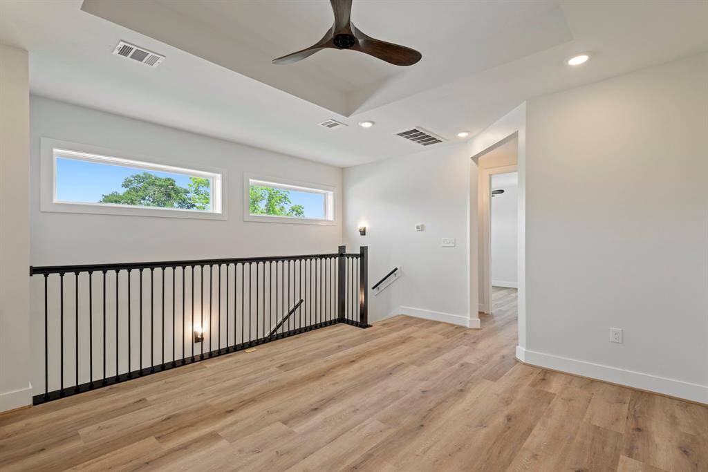 Head upstairs to discover a bright, airy game room that does it all—stylish lighting and a ceiling fan keep things comfortable, while a thoughtful built-in desk creates the perfect spot to work or study. Two levels of refined comfort flow seamlessly together, creating an atmosphere where modern elegance meets daily livability.