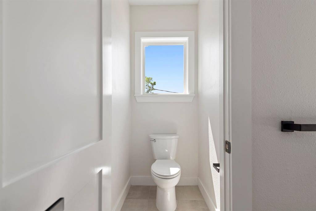 Thoughtful design in the primary bathroom includes a enclosed water closet.
