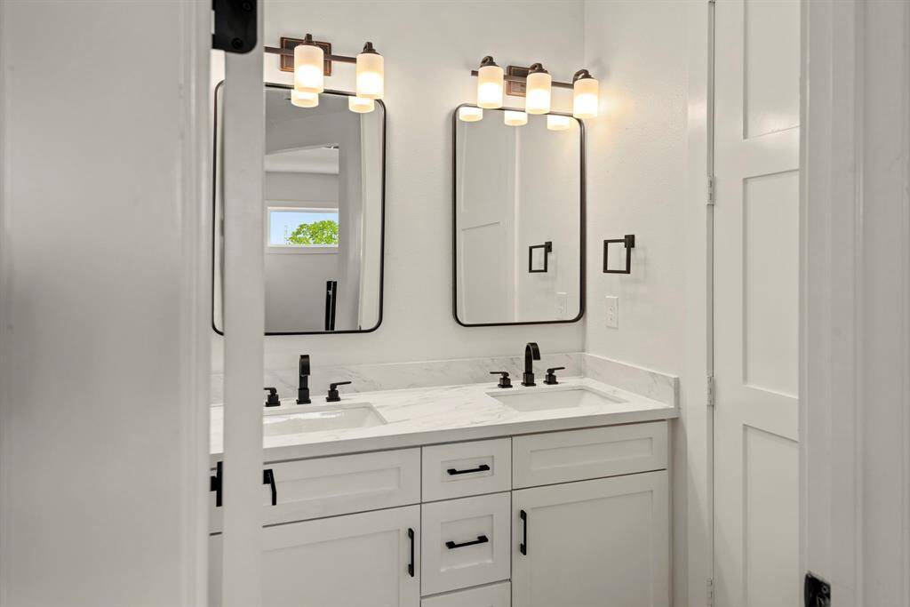 A stylish double vanity with framed mirrors, premium upgraded finishes, and exceptional builder craftsmanship for a refined and luxurious touch.