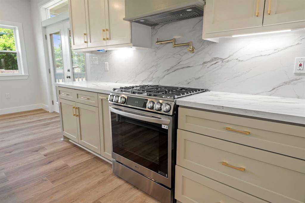 Kitchen is complete with spacious gas range with convenient pot filler, and smart storage solutions including dedicated pot drawers.