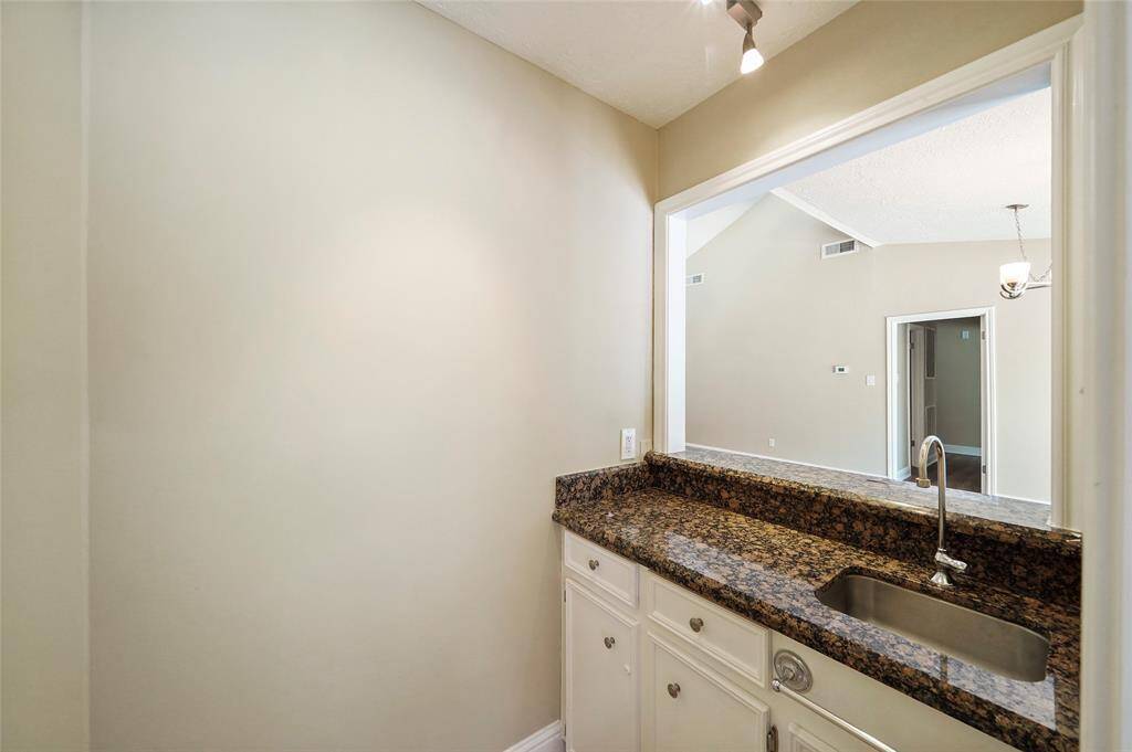 Wet bar off of breakfast area looking out to living room