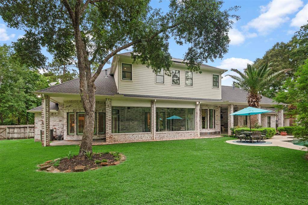 The covered patio to the left is off of the primary bedroom with direct access. The glass enclosed climate controlled sun-room is in the middle. To the right is another huge covered patio with the outdoor summer kitchen and access to the pool bath.