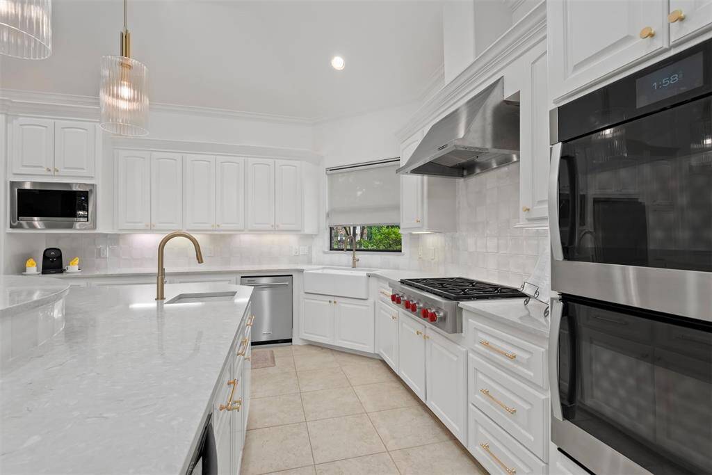 Wolf cook top, double ovens, farmhouse sink, updated lighting, gorgeous backsplash
