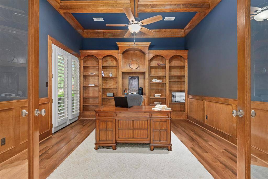 Dedicated study #1 at the front of the home with French doors, wood floors and custom built in.