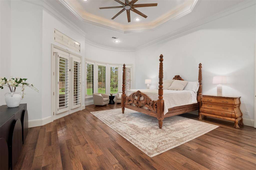 Luxurious primary bedroom with access to one of the cover patios and the pool.